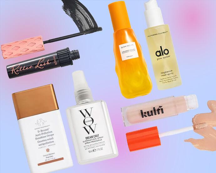 A diagonal pastel collage of beauty products from Benefit, Glow Recipe, AloY, Drunk Elephant, Color Wow, Kulfi, and Drunk Elephant, featuring mascara, foundation, sunscreen, serum, and lip gloss