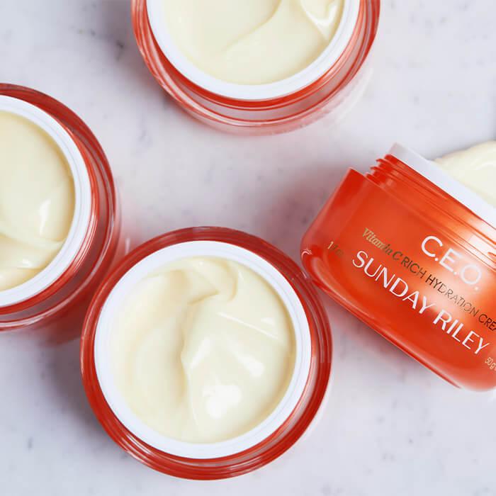 Jars of SUNDAY RILEY C.E.O. Vitamin C Rich Hydration Cream swatched on marble surface