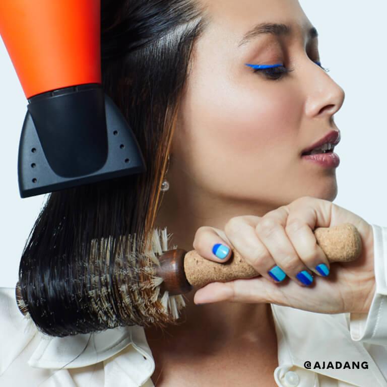 Aja Dang blowdries her hair.  Desktop