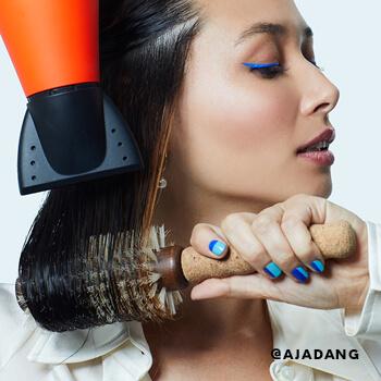 Aja Dang blowdries her hair.  Mobile