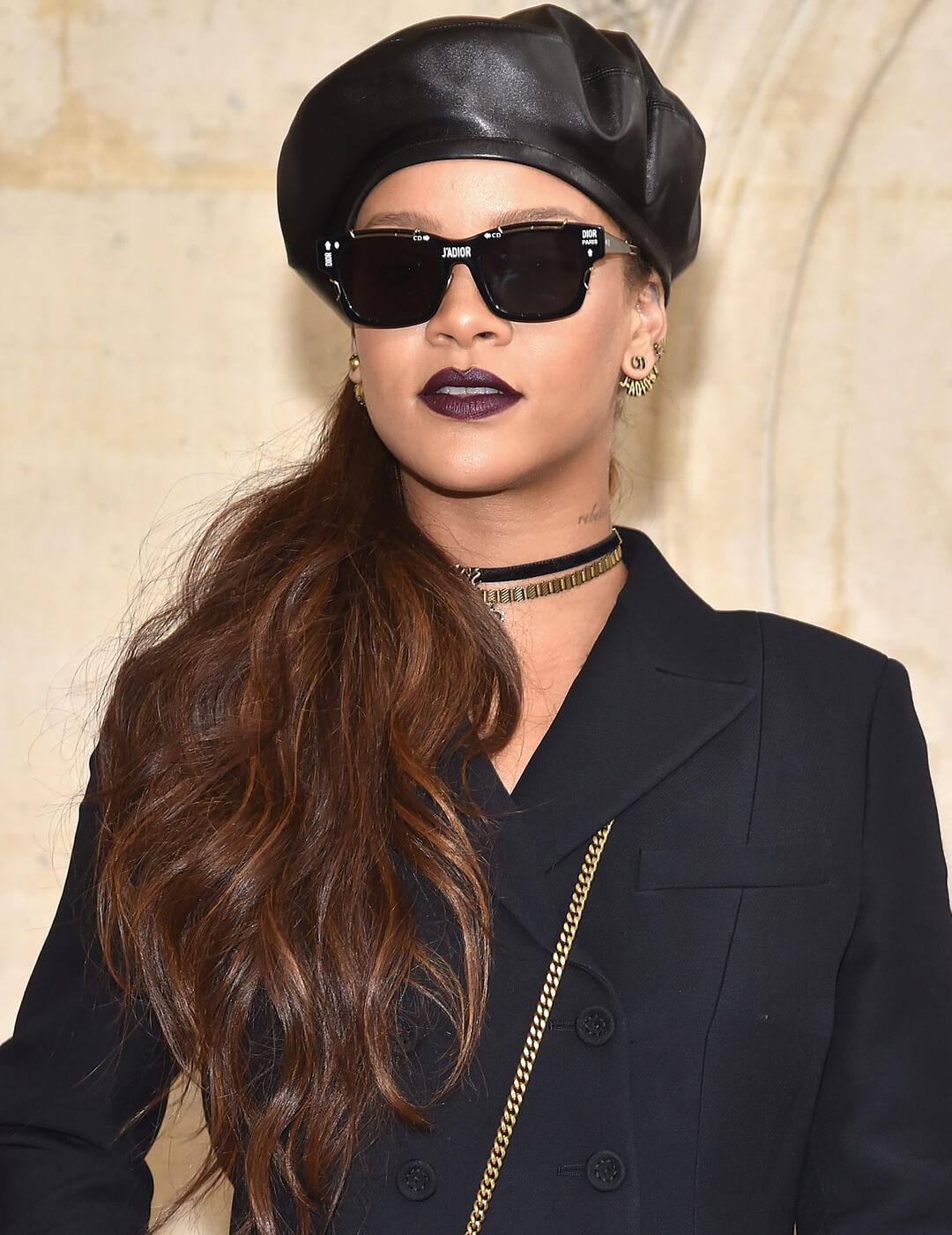 Rihanna in an all-black ensemble with a side ponytail hairstyle Mobile