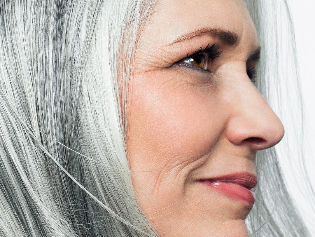 Side profile of a beautiful mature woman with gray hair Desktop