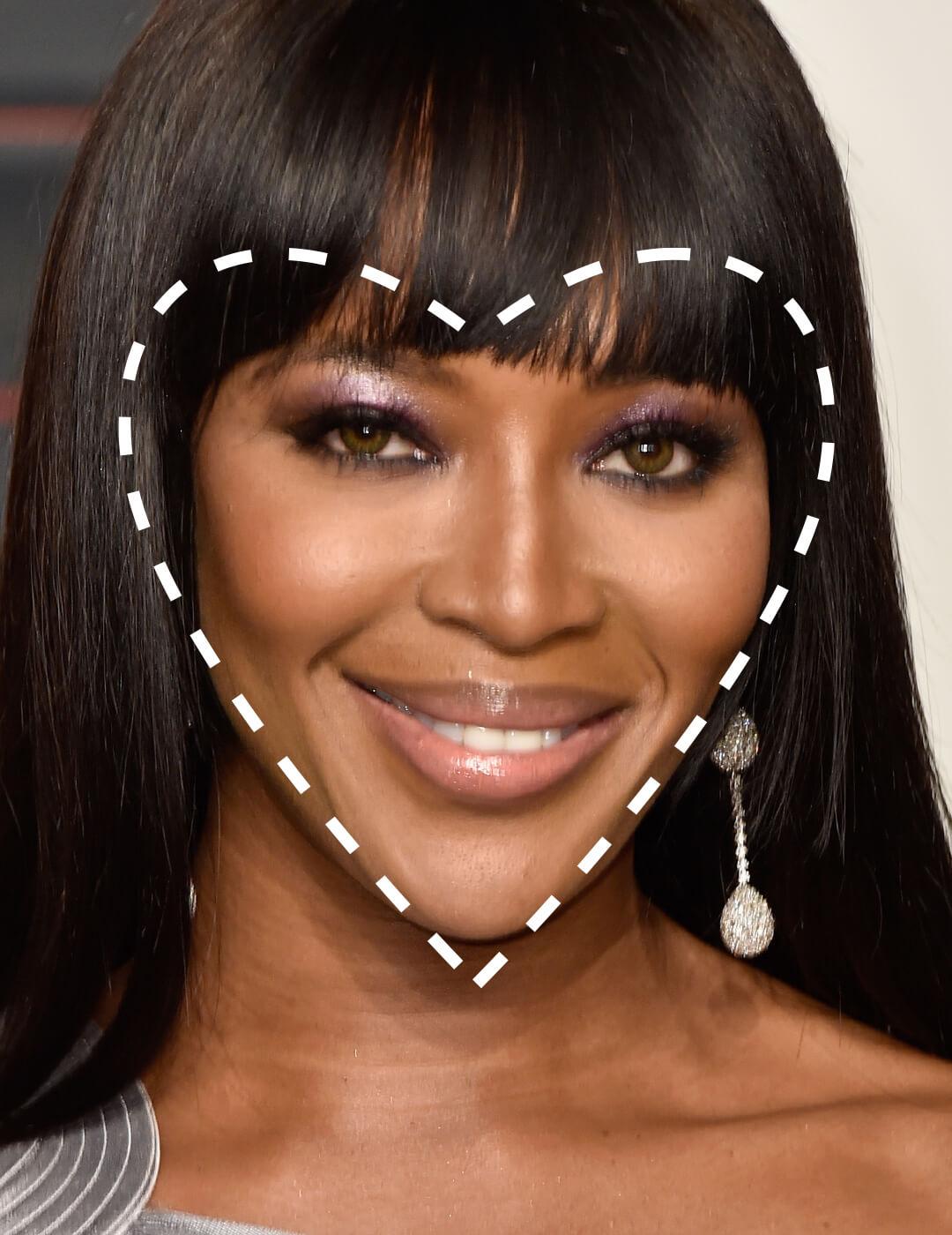 Close-up of a smiling Naomi Campbell with a broken line heart shape overlay Desktop