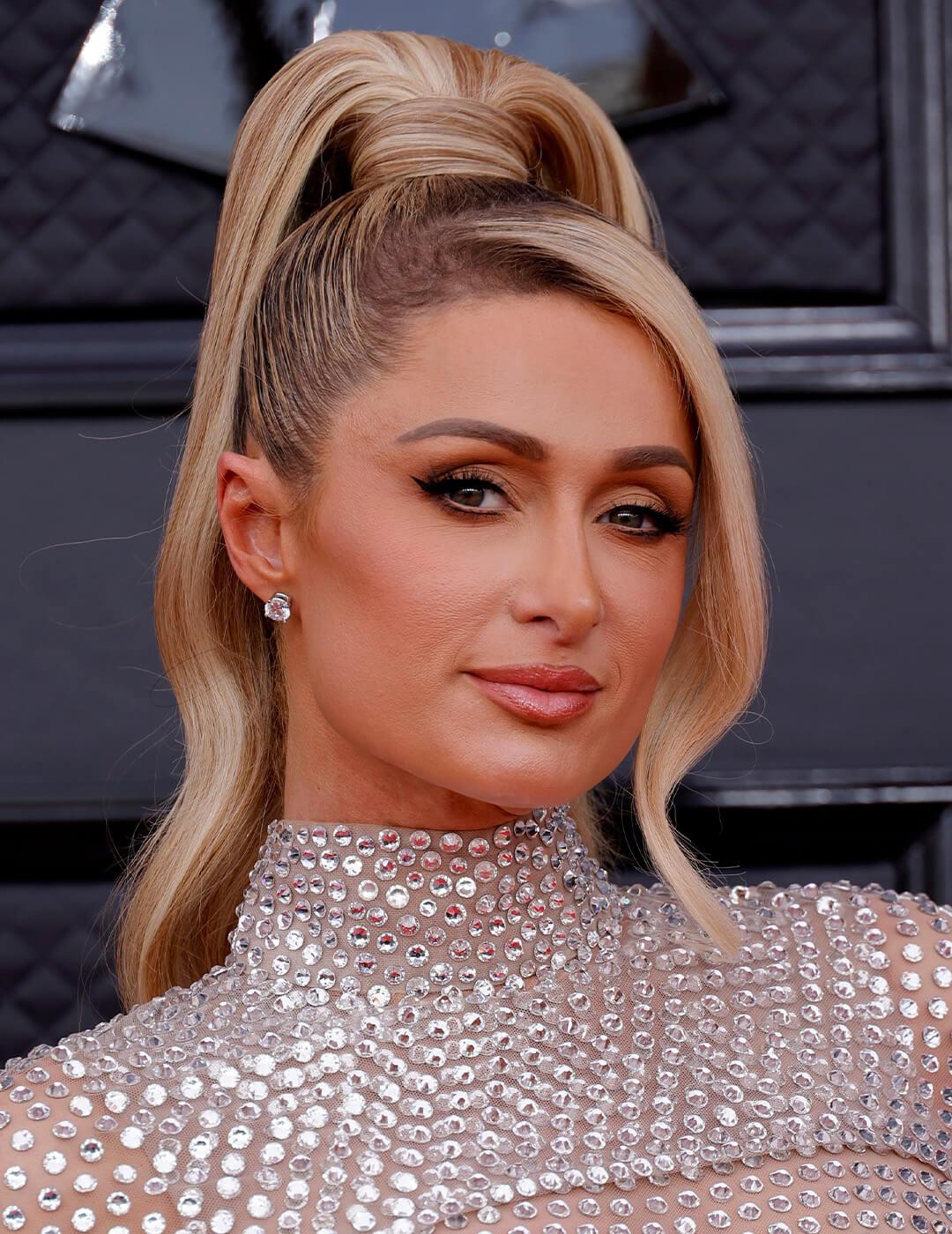 Paris Hilton rocking a high ponytail hairstyle and sequined dress on the red carpet Desktop