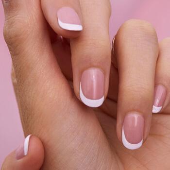 A closeup image of a French tip mani Mobile