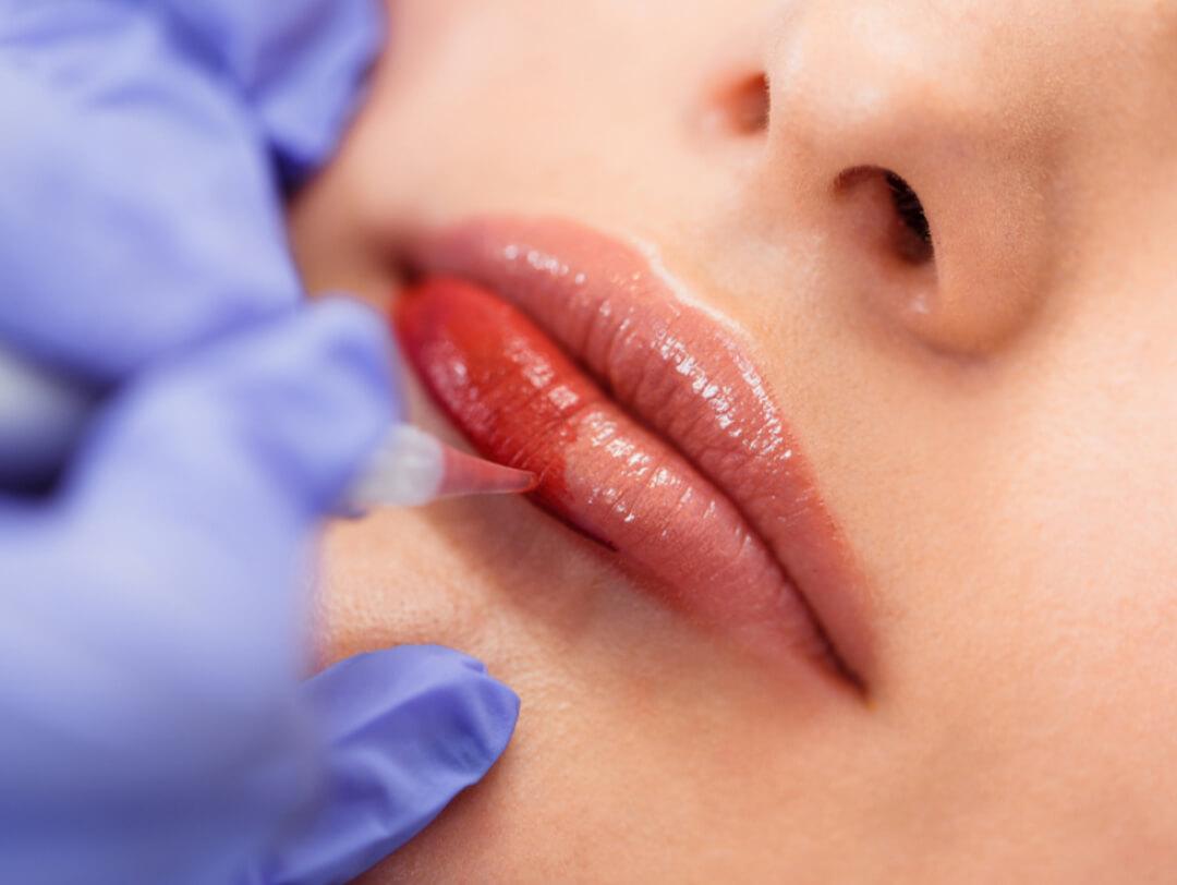Close-up of a woman's lips getting permanent makeup Desktop