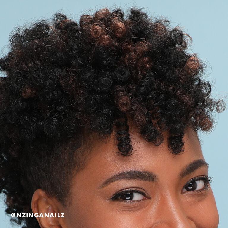 A close-up of Nzinga Nailz' crochet braids. Desktop