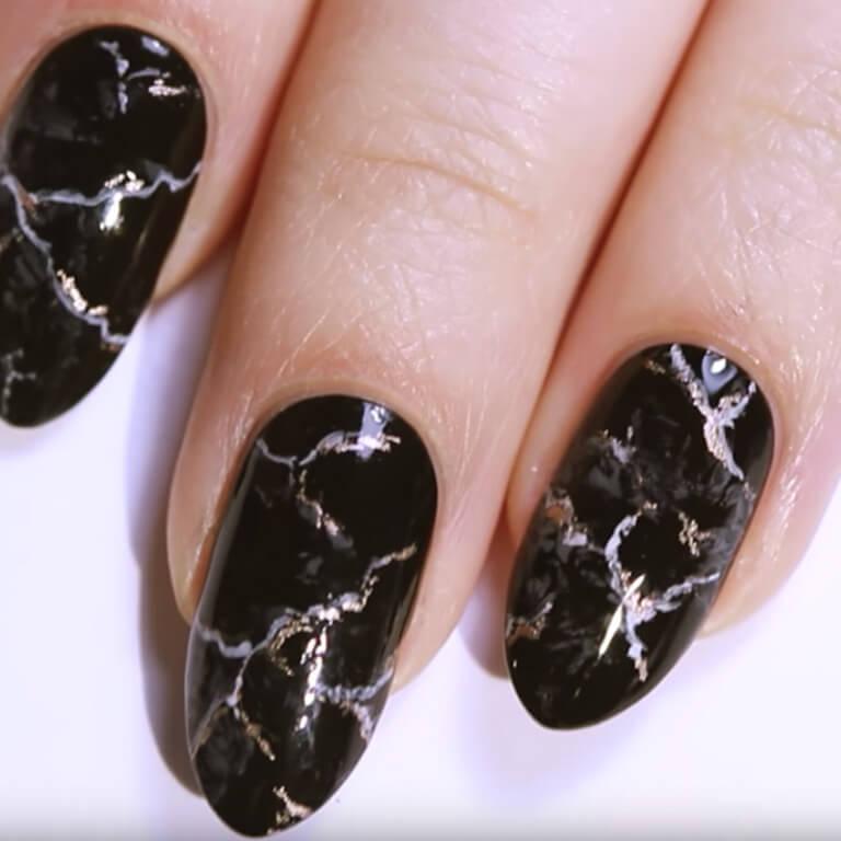 A close-up of the black marble nail art you can create by following these steps. Desktop