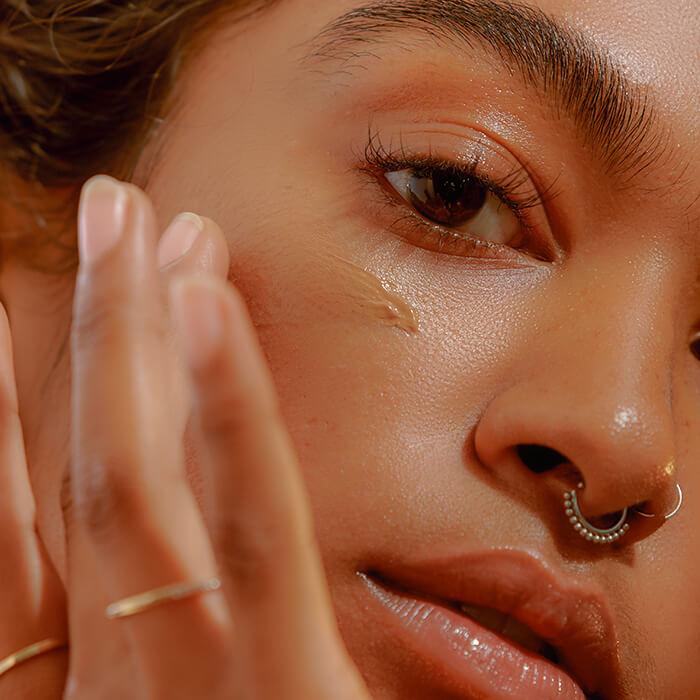 NYC Party Makeup Tutorial | Step-By-Step Glam Guide for a Stunning New York Look 3 Woman blending foundation with sponge.