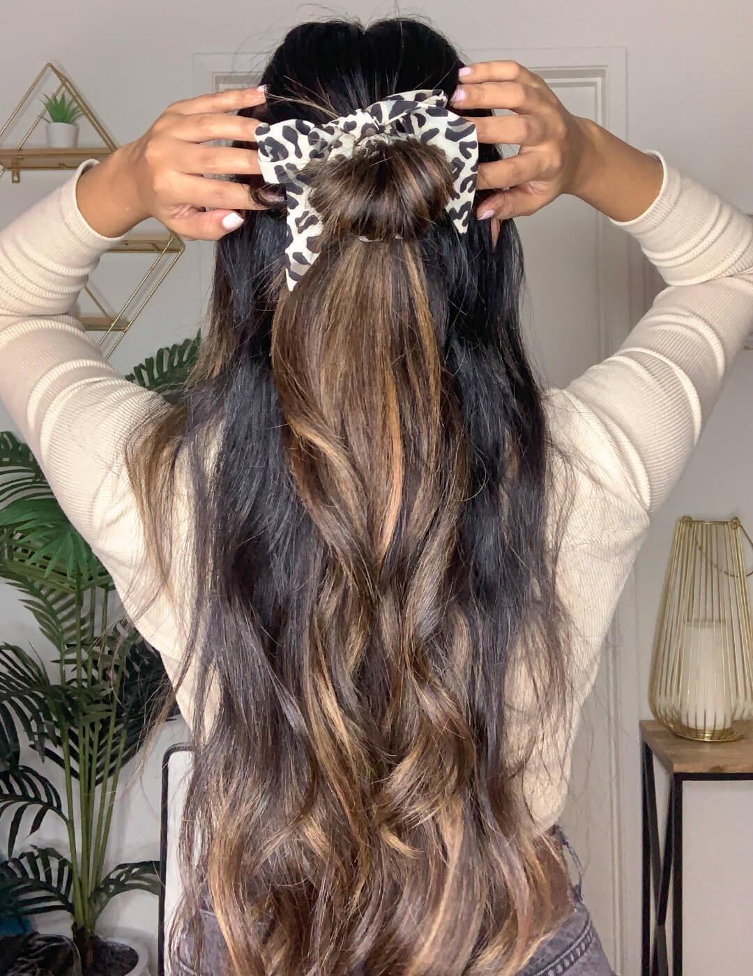 Cynthia Dhimdis rocking a half up and half ponytail hairstyle with her back to the camera Desktop