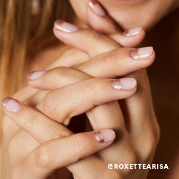 A close-up of Roxette Arisa's glitter nail polish manicure. Mobile