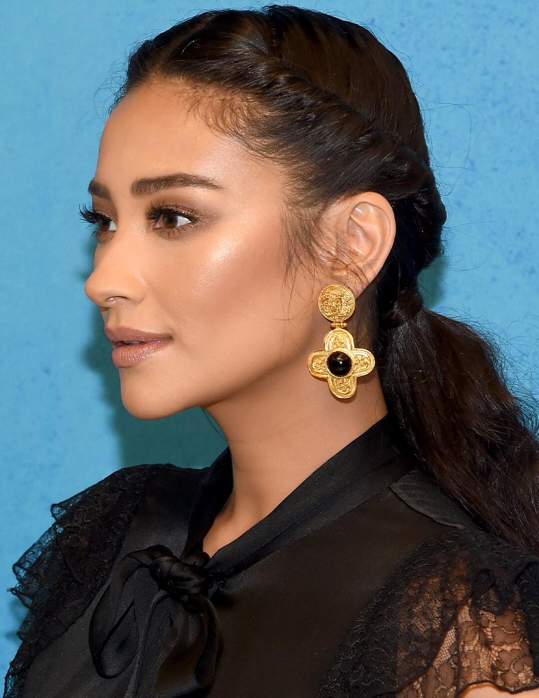 Shay Mitchell rocking a sheer black dress, gold earrings, and twist back ponytail hairstyle Desktop