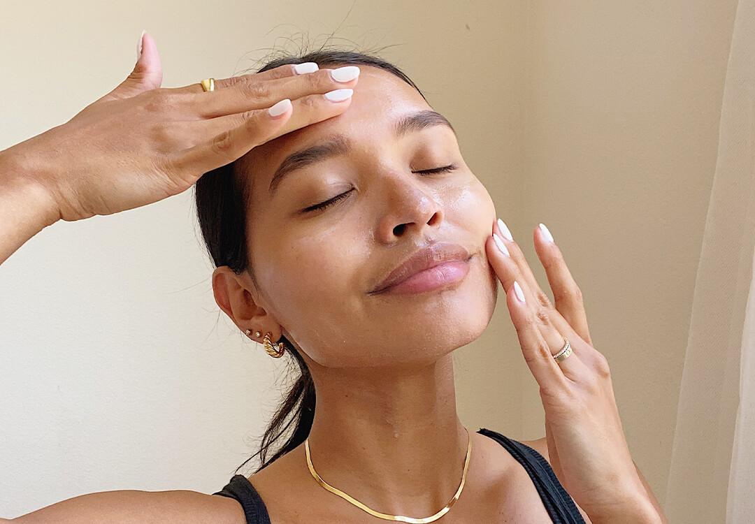 Image of a woman massaging her face with her hands Mobile