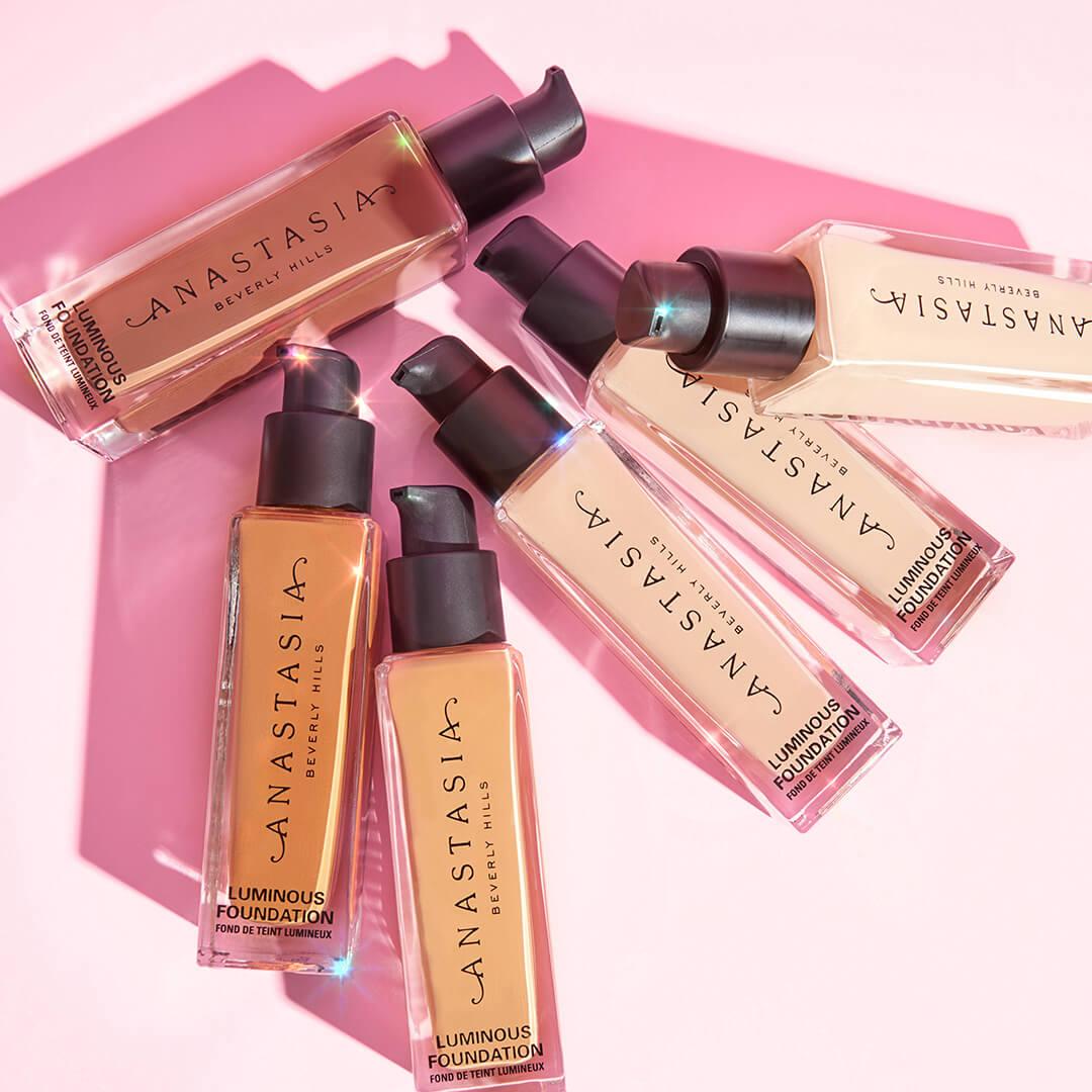 A photo of different shades of ANASTASIA BEVERLY HILLS Luminous Foundation on a pink background Desktop
