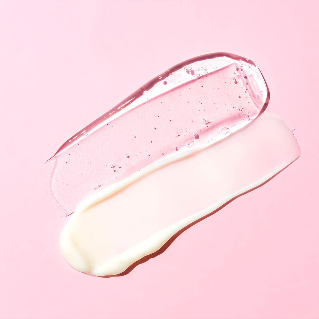 Two distinct skincare product textures, one a translucent gel and the other a smooth cream, are displayed against a pink backdrop Mobile
