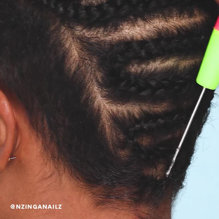 A hairstylist shows how to loop a hair extension into your cornrows using a crochet hook. Desktop