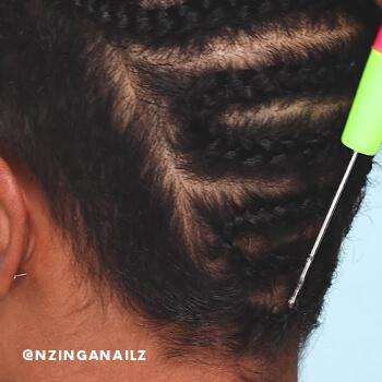 A hairstylist shows how to loop a hair extension into your cornrows using a crochet hook. Mobile
