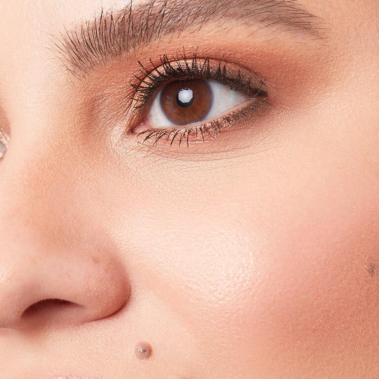 A closeup image of a model wearing copper eyeshadow and subtle blush Desktop
