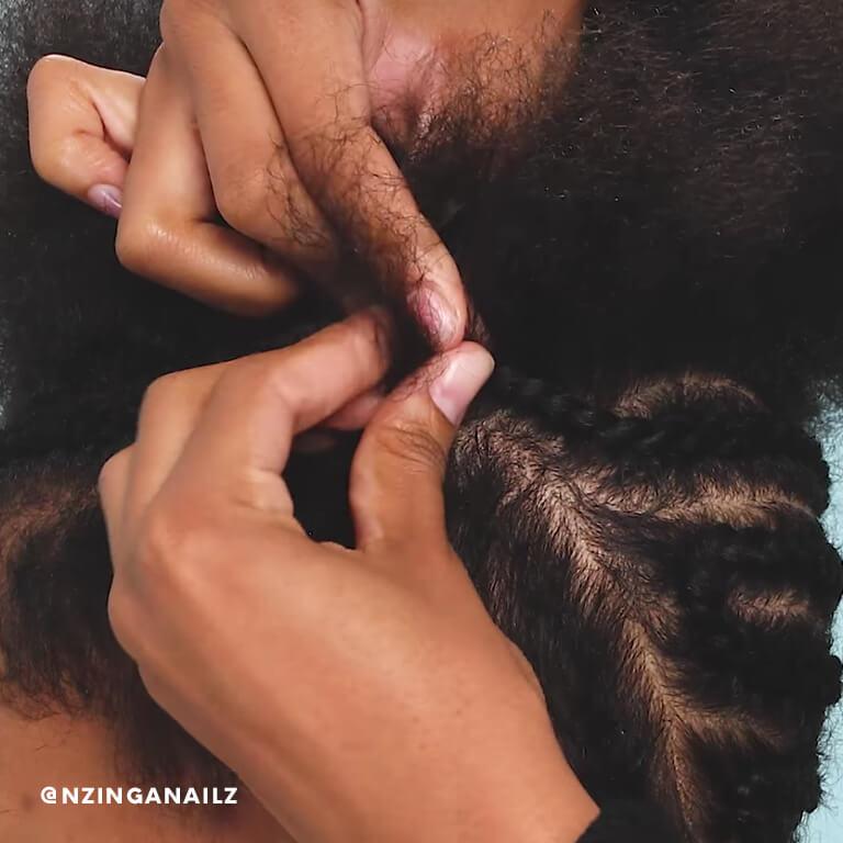 A close-up of a hairstylist creating cornrows.  Desktop