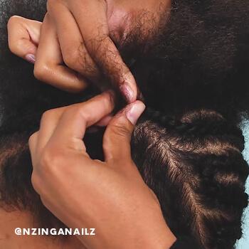 A close-up of a hairstylist creating cornrows.  Mobile