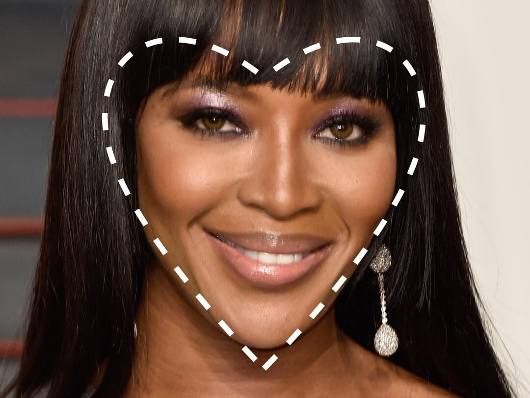 Close-up of a smiling Naomi Campbell with a broken lines heart shape overlay Desktop