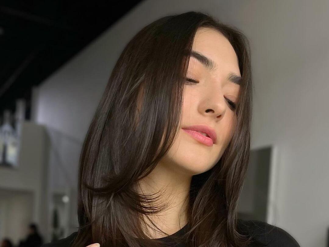 Young woman showing off her butterfly haircut hairstyle Desktop