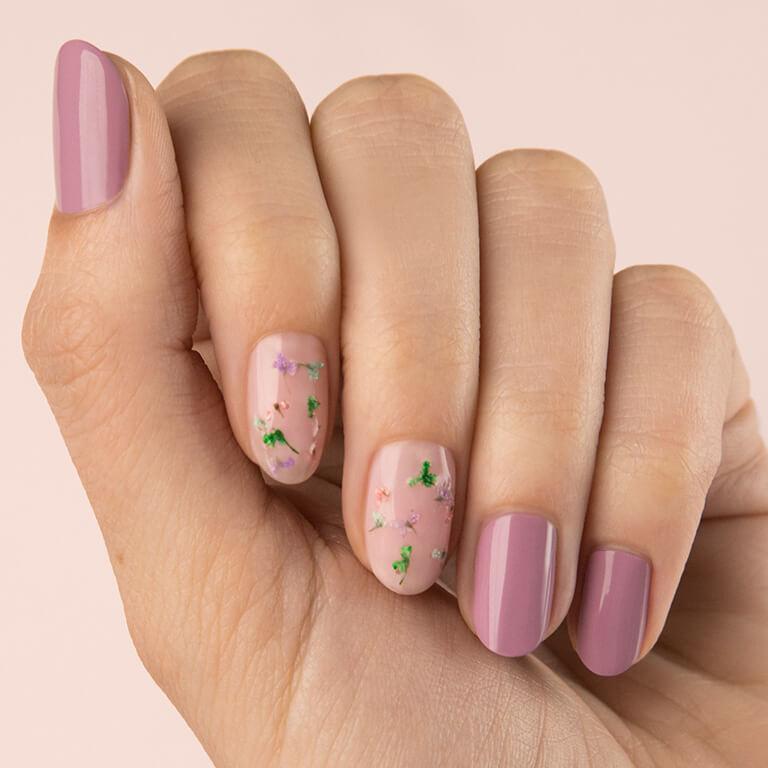 Close-up image of a model's hand with dried flowers nail art Desktop