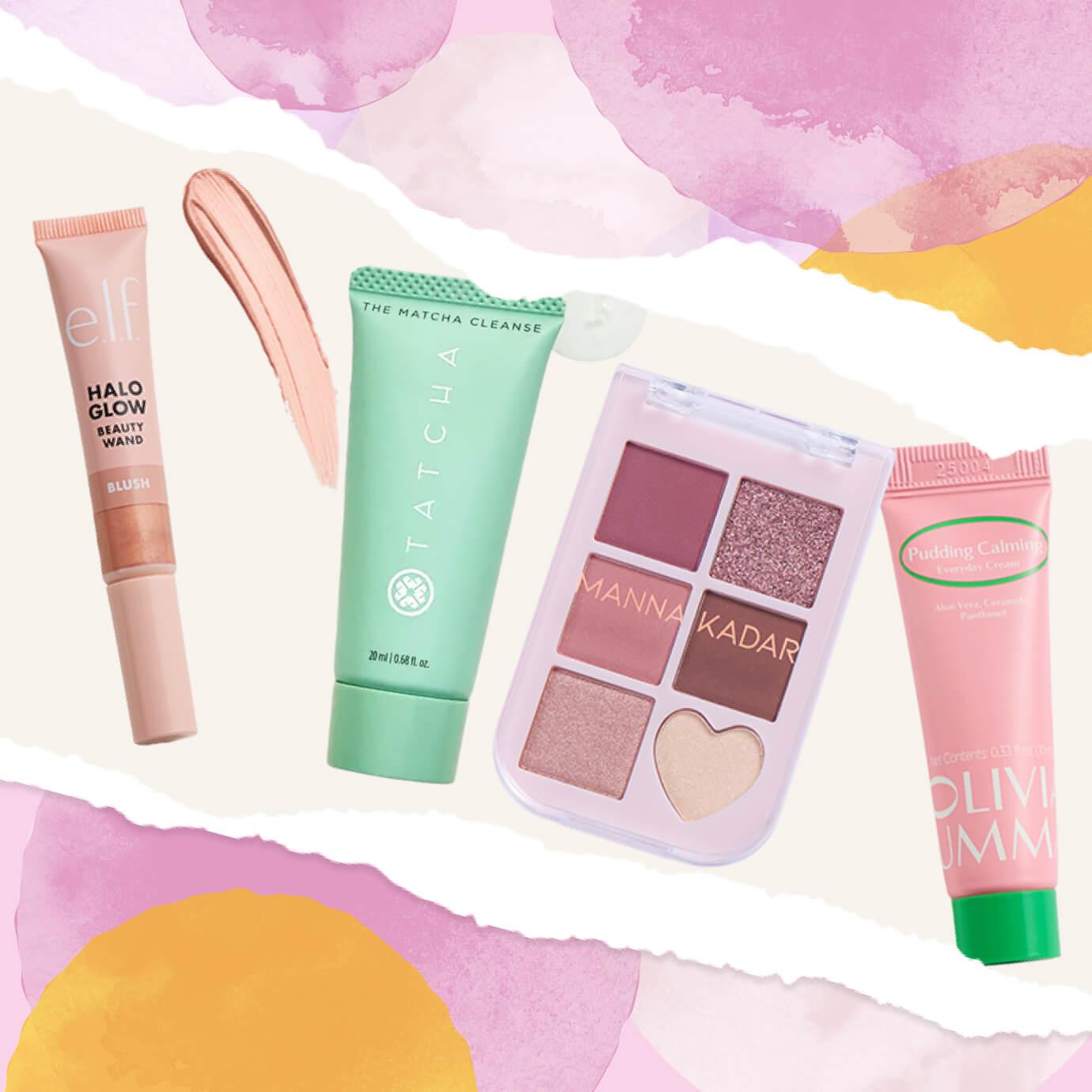 Flat lay of beauty products on a pastel watercolor background, including e.l.f. Halo Glow Beauty Wand blush, Tatcha The Matcha Cleanse, a Manna Kadar eyeshadow palette, and OLIVIAUMMA Pudding Calming Everyday Cream.