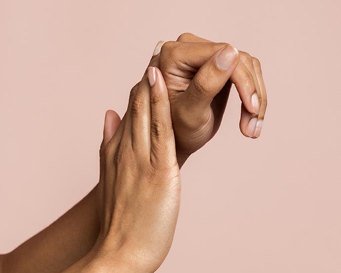 Hands of unrecognizable woman massaging and applying moisturizing lotion. Concept of beauty and skin care.