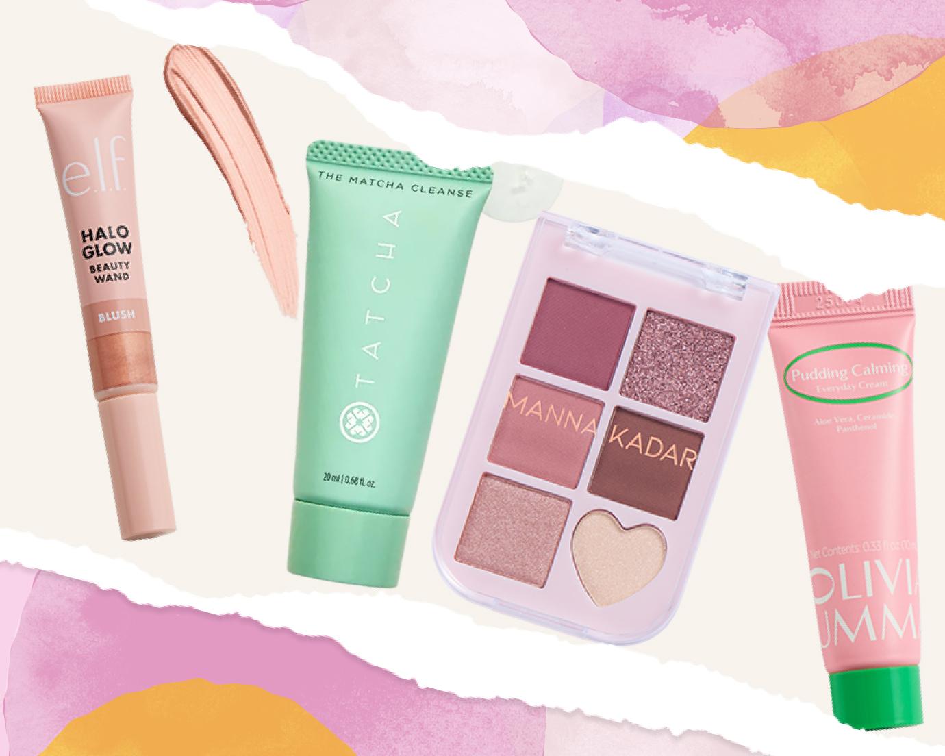 Flat lay of beauty products on a pastel watercolor background, including e.l.f. Halo Glow Beauty Wand blush, Tatcha The Matcha Cleanse, a Manna Kadar eyeshadow palette, and OLIVIAUMMA Pudding Calming Everyday Cream.