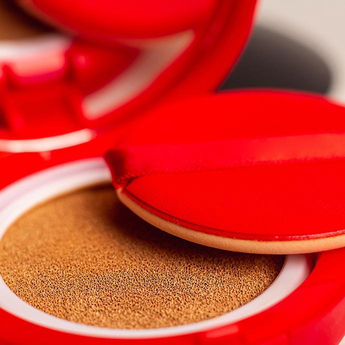 Foundation cushion with sponge and puff on white background