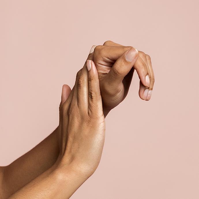 Hands of unrecognizable woman massaging and applying moisturizing lotion. Concept of beauty and skin care.