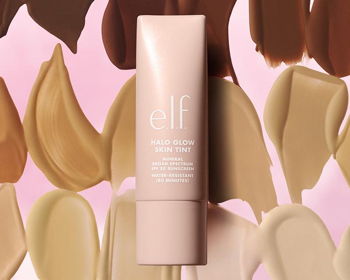 Product image of e.l.f. Halo Glow Skin Tint SPF 50 sunscreen tint, featuring a lightweight complexion product with broad-spectrum sun protection against a backdrop of blended skin-tone swatches.