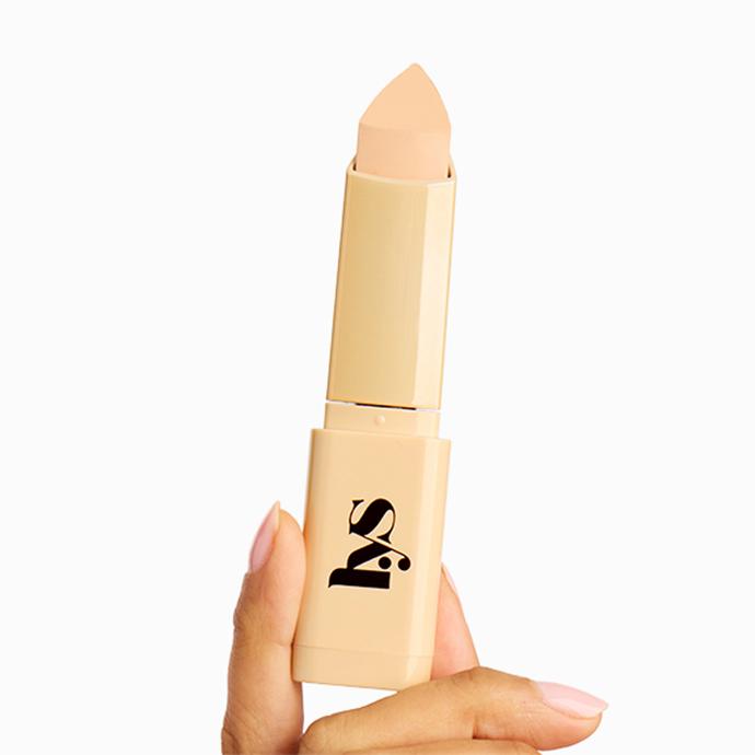 LYS Beauty Triple Fix Blurring Skin Tint Foundation Stick held in hand, showing a creamy complexion stick designed for buildable coverage and a natural, blurred finish.