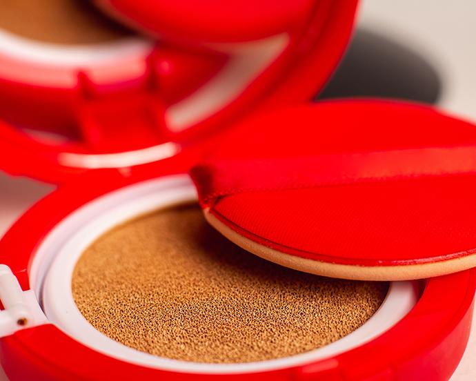 Foundation cushion with sponge and puff on white background