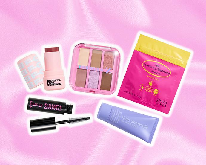 Curated beauty assortment featuring makeup and skincare favorites—including blush, eyeshadow, mascara, exfoliating toner pads, and nourishing moisturizer—set against a pink satin backdrop.