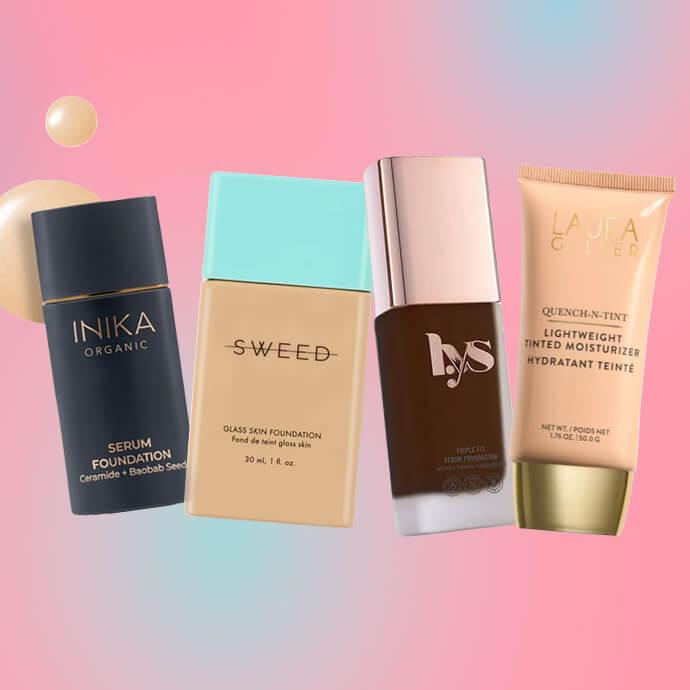 A row of foundation bottles from brands Inika, Sweed, Lys and Laura Geller stand diagonally against a soft pink and pastel gradient background