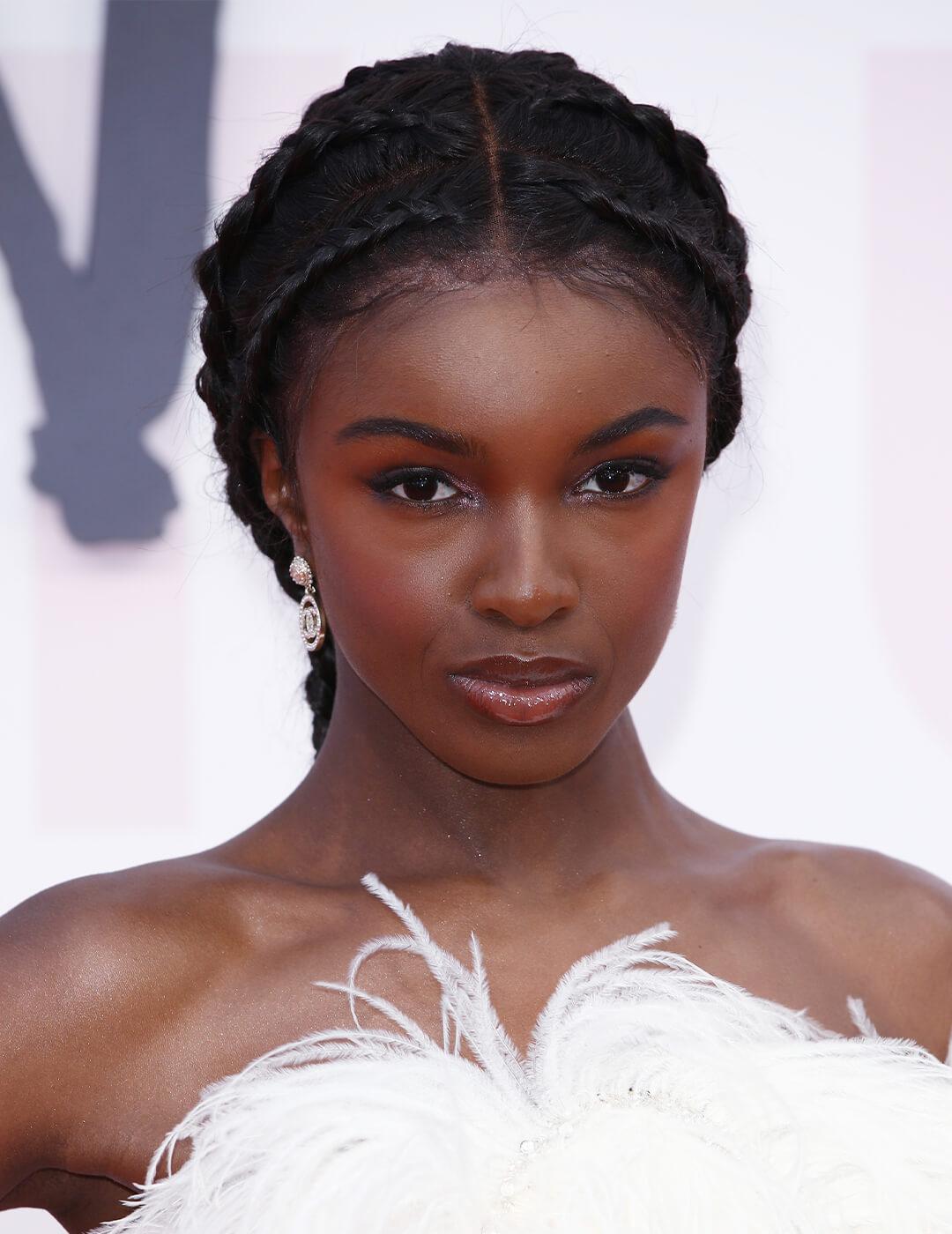 Model Leomie Anderson looking fierce in a side braids hairstyle Desktop
