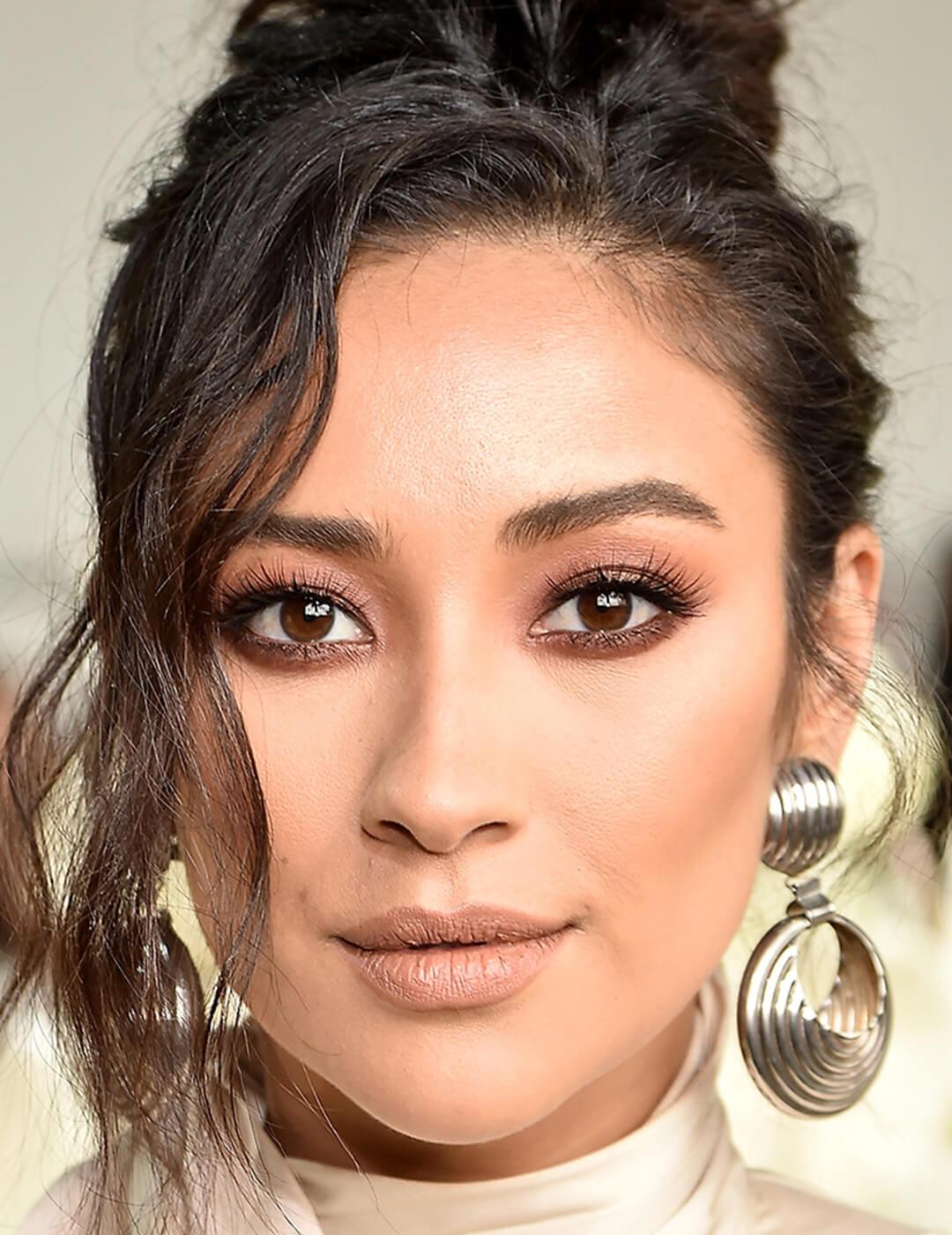 Close-up of Shay Mitchell with a smoky eyeshadow makeup look paired with matte nude lips Mobile