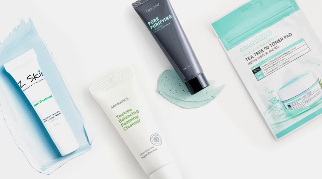 Image of four tea tree oil-based skincare products swatched on white background Desktop