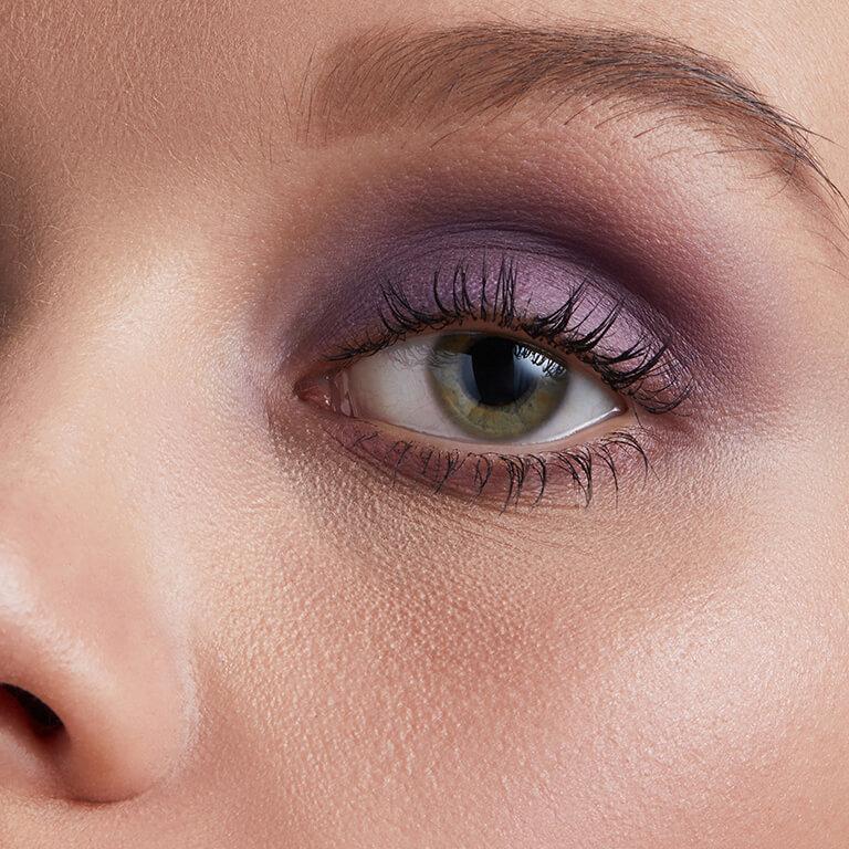 A closeup image of a model wearing purple eyeshadow and an image of eyeshadow pots and palettes Mobile