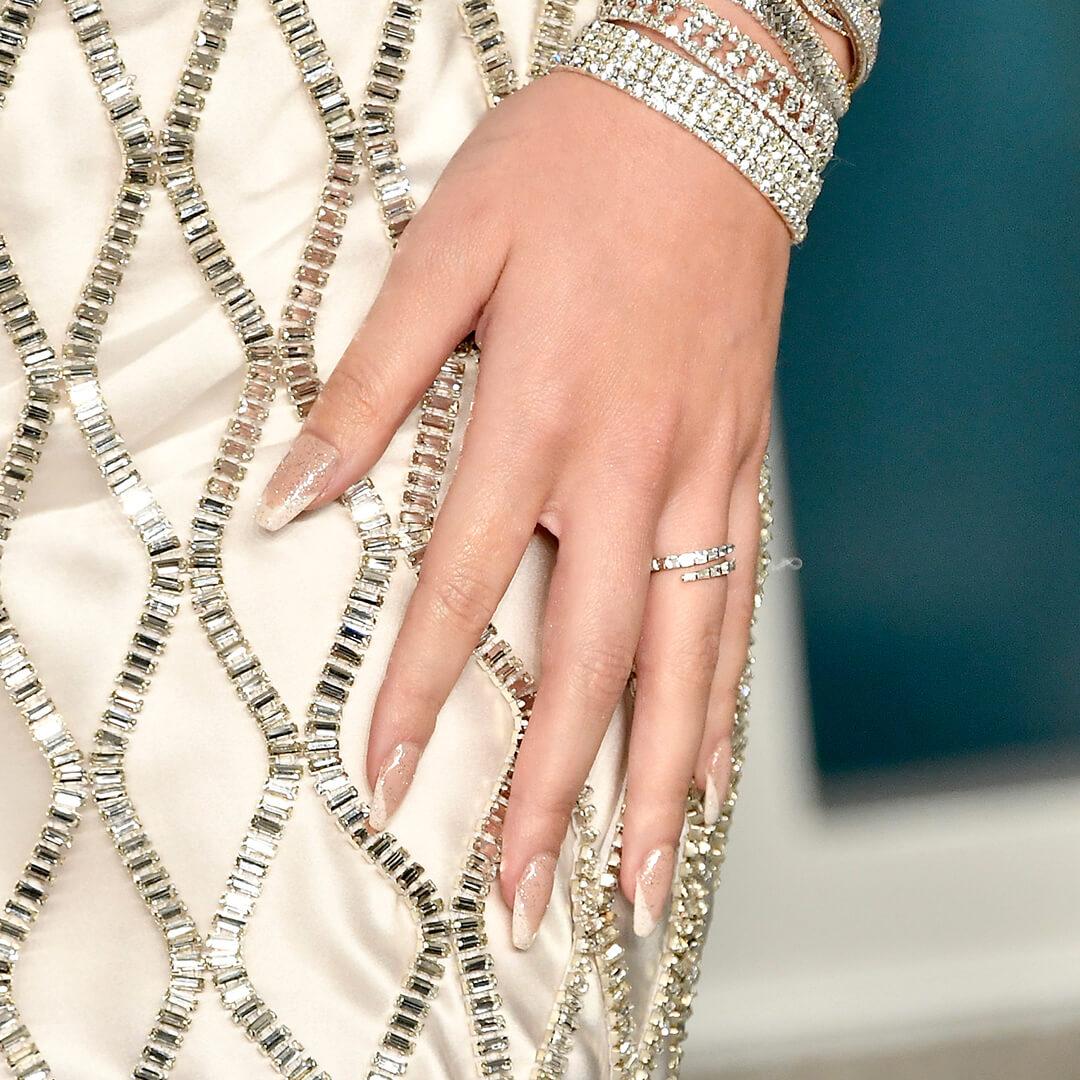 Close-up of Hailee Steinfeld's glass French mani against bejewelled dress Mobile