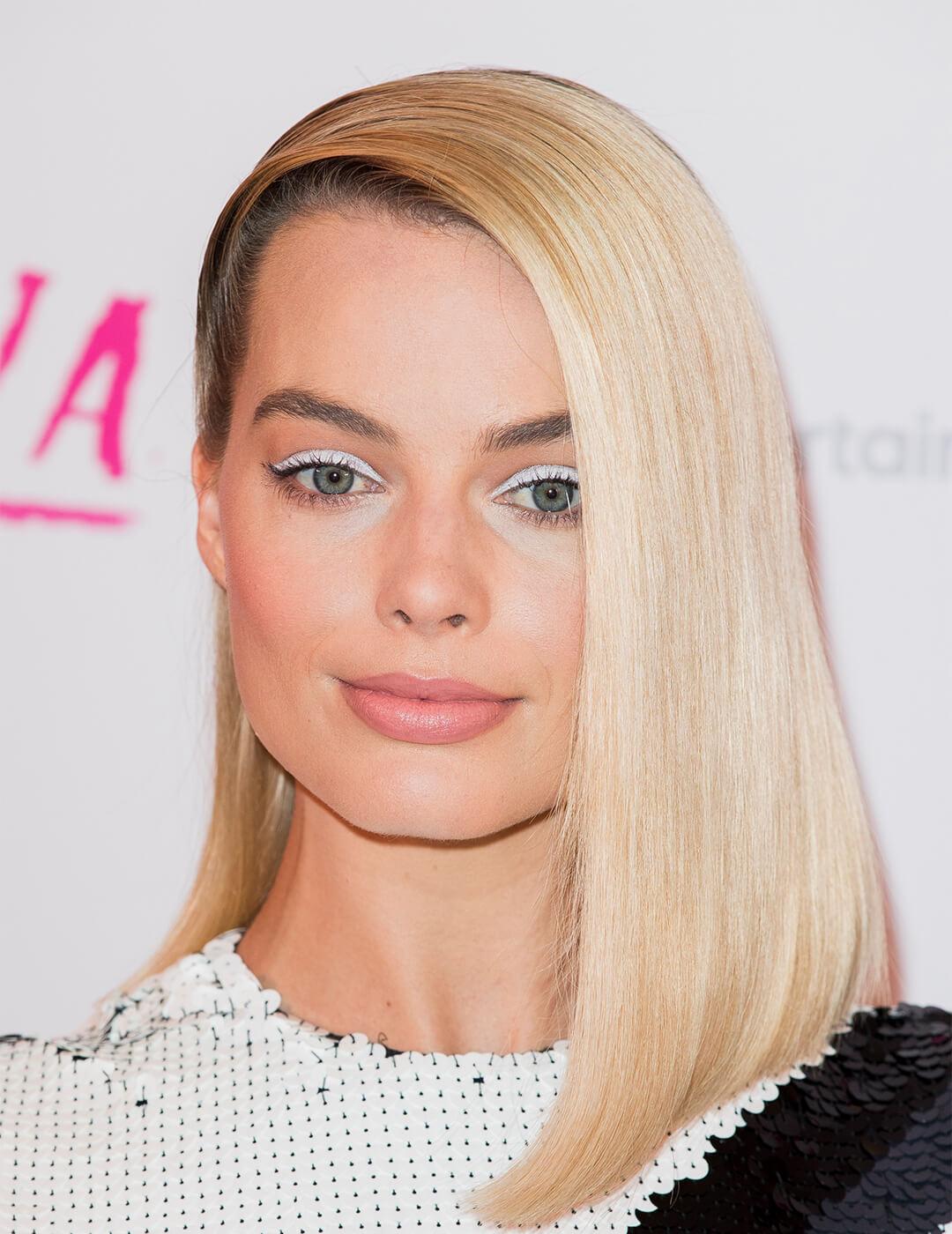 Close-up of Margot Robbie rocking a white eyeshadow makeup look and deep side parted hairstyle Desktop