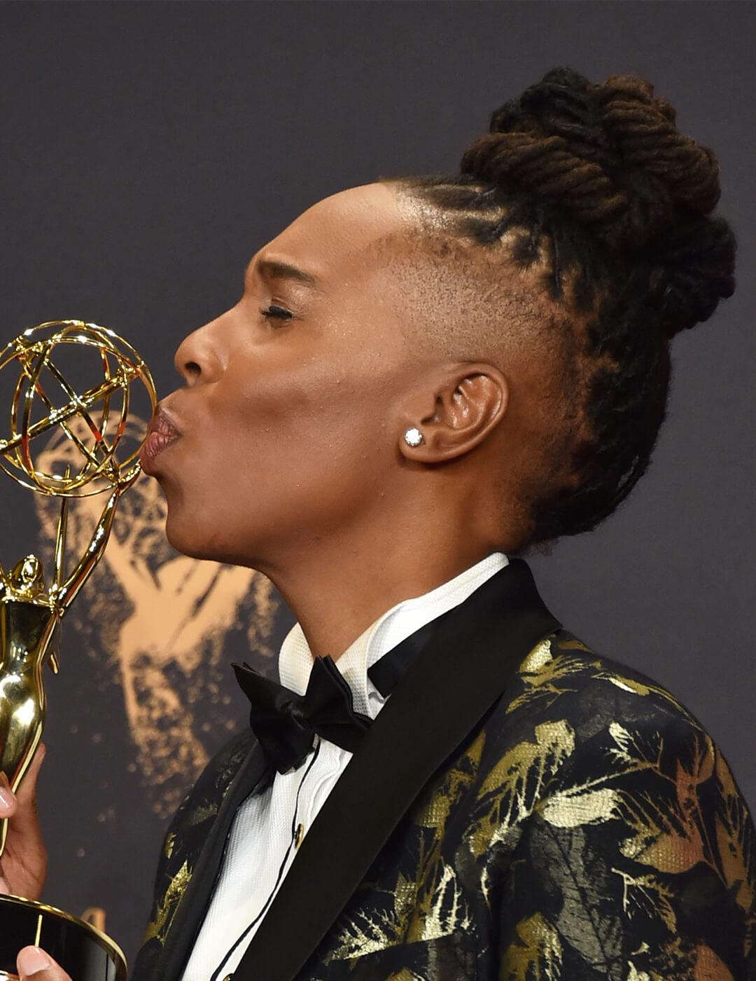 Lena Waithe in a black and gold tuxedo rocking her faded top bun hairstyle and kissing her Annual Primetime Emmy Award Desktop