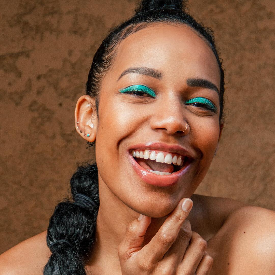 Close-up image of Bianca Alexa with a bright green eyeshadow look paired with a nude peach lipstick look Mobile