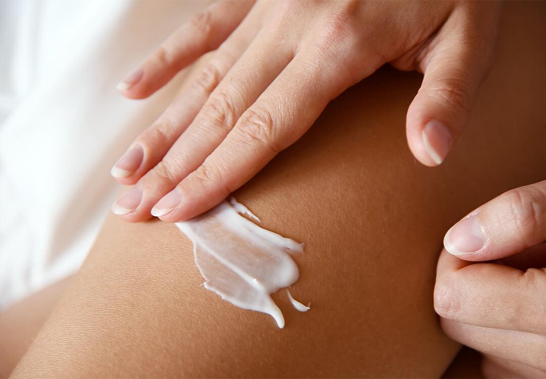 Close-up image of a woman's hand putting lotion on skin Mobile