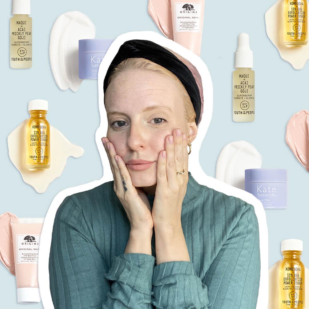 Close-up image of Hannah Cassidy touching her face with her hands and wearing a green sweater and black headband on skincare products background Desktop