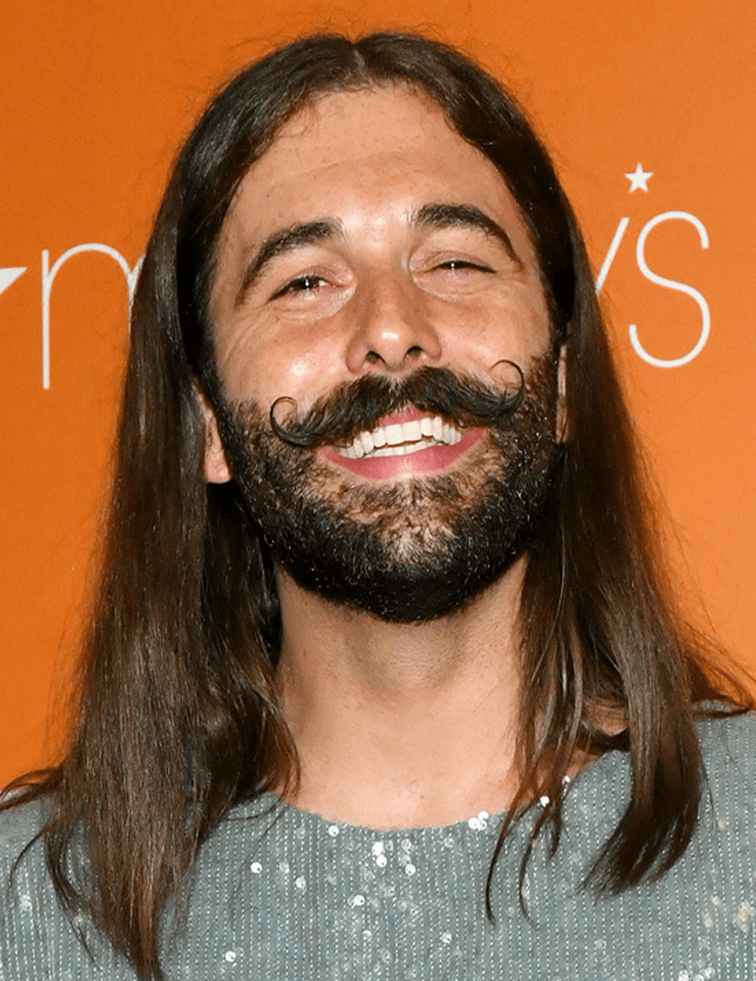 Jonathan Van Ness rocking a sequined top and long hairstyle complete with beard and mustache Desktop