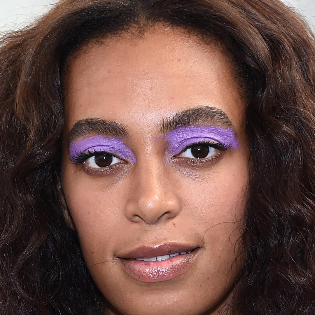 Close-up image of Solange Knowles rocking a bold purple eye makeup look Desktop