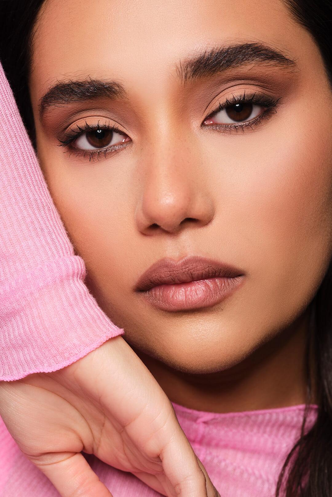 Close-up of a posing model with a sultry smoky eye makeup look Desktop